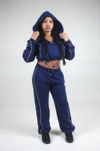 Modella con cappuccio alzato in completo VINKS blu navy, felpa crop e pantalone con coulisse alle caviglie